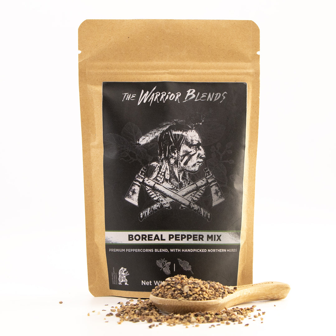 Boreal Pepper Mix pouch with wooden spoon and cracked pepper blend on white background