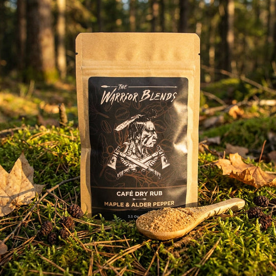 Café Dry Rub Maple & Alder Pepper seasoning pouch in boreal forest moss with golden hour light and alder cones