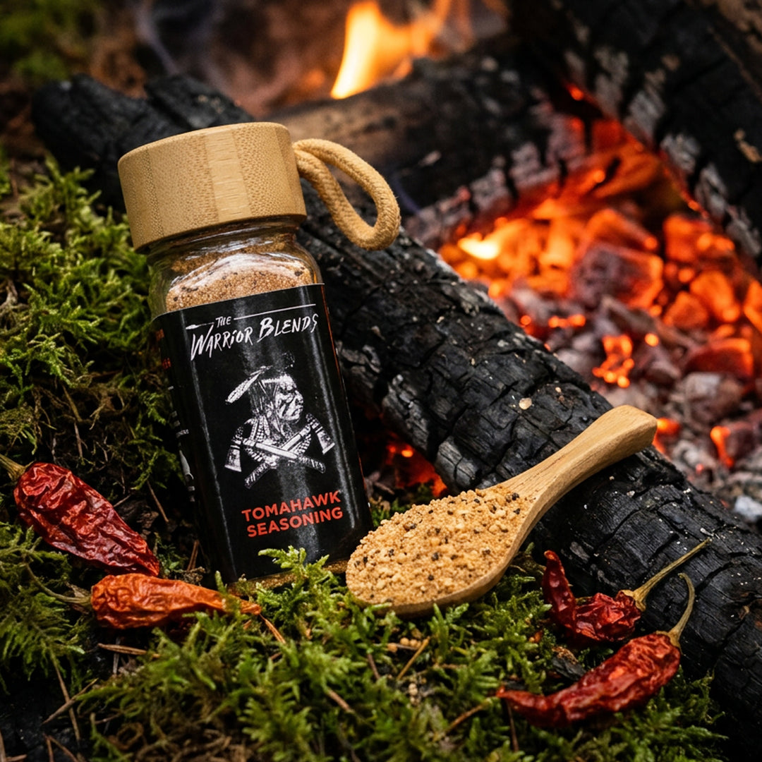 Tomahawk Blend seasoning jar beside glowing campfire with ghost peppers and moss