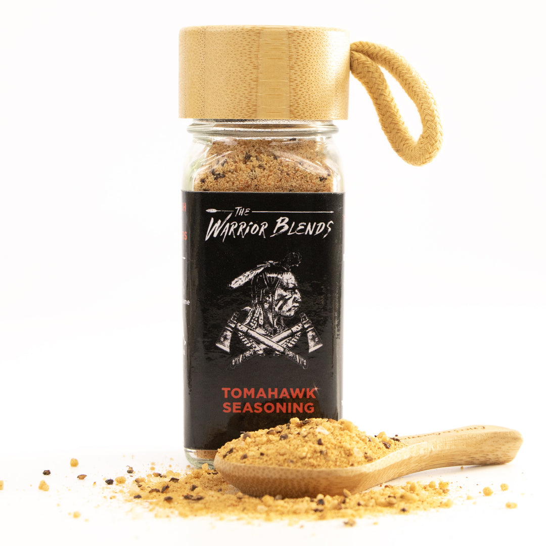 Tomahawk Blend seasoning jar with bamboo cap and wooden spoon on white background