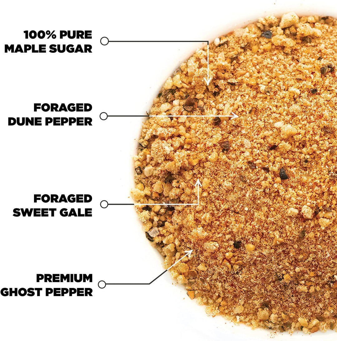 Close-up texture of Tomahawk Blend seasoning with maple sugar, dune pepper, sweet gale, and ghost pepper callouts
