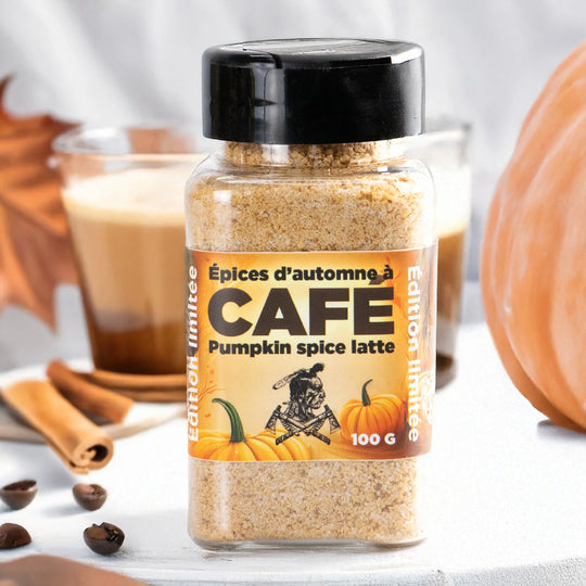Jar of pumpkin spice latte coffee spices with a pumpkin and coffee cup in the background.