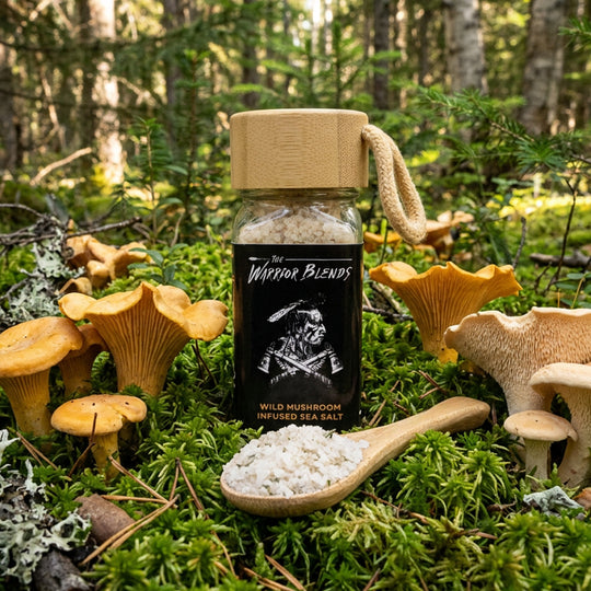 Wild Mushroom Infused Sea Salt jar in forest moss surrounded by wild mushrooms and wooden spoon